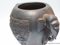 Grote art déco vaas in africanistische stijl. handgrepen elk in de vorm van een olifantenkop waarvan de slurf een ring vasthoudt. decoratie in reliëf met een olifant aangevallen door roofdieren. verzilverd metaal. hoogte: 35 cm - afbeelding 3 van  3