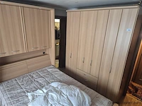 Slaapkamer met grote kleerkast en klein kastje - afbeelding 1 van  6
