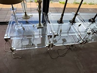 2 vintage tweelaagse salontafels van helder plexiglas en glas met metalen hoekdetails 70x70 cm