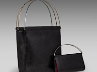 A cartier black 'trinity' top handle bag and a 'trinity' wallet