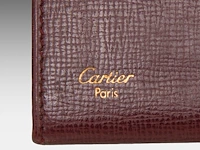 A cartier burgundy 'trinity' top handle bag, wallet and two 'must de cartier' wallets - afbeelding 2 van  16