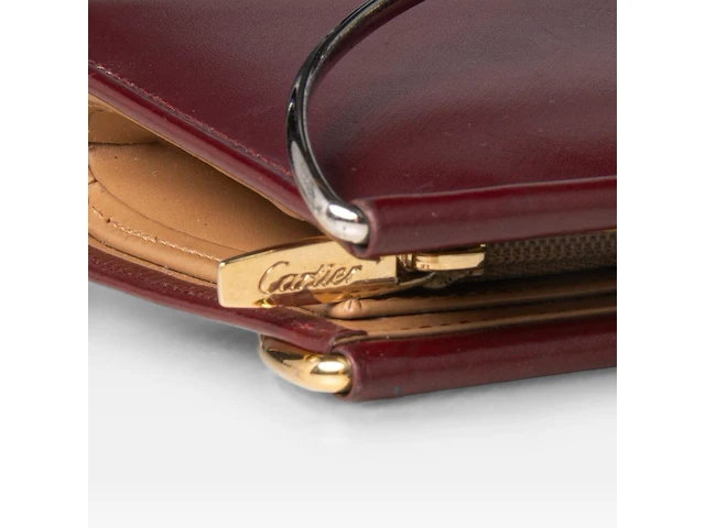 A cartier burgundy 'trinity' top handle bag, wallet and two 'must de cartier' wallets - afbeelding 7 van  16