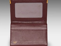 A cartier burgundy 'trinity' top handle bag, wallet and two 'must de cartier' wallets - afbeelding 16 van  16