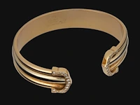 A cartier ressort 'double c' bracelet in 18ct yellow gold and diamonds, weight: 26,9 g (+)