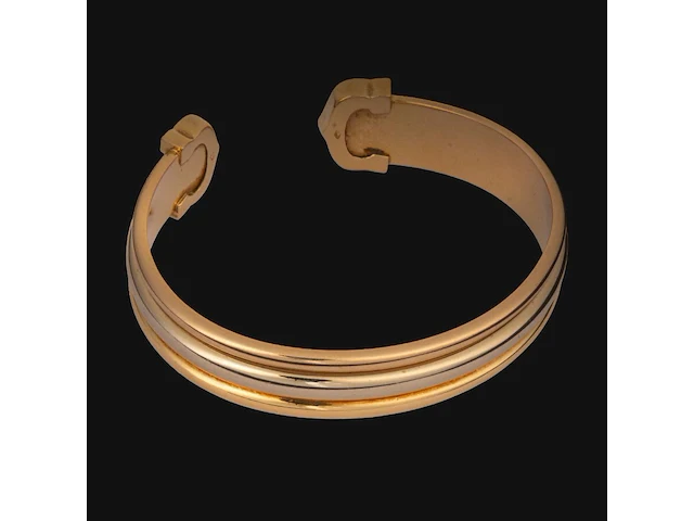 A cartier ressort 'double c' bracelet in 18ct yellow gold and diamonds, weight: 26,9 g (+) - afbeelding 6 van  8
