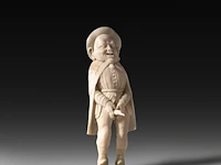 A carved bone folk figure of a man holding his bird, germany, late 19thc 10.5 cm. (4.12 in.)