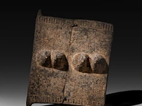 A carved wooden 'ge tanga' door decorated with two pairs of breasts, dogon people, mali 48 x 38 cm. (18.89 x 14.96 in.)
