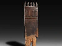 A carved wooden traditional door with five phalli on top, gurage people, ethiopia 122 x 32 cm. (48.03 x 12.59 in.)