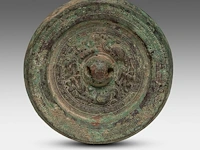 A chinese bronze 'mythical animals' mirror, with inscription, presumably han, ø 12 cm