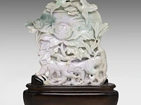 A chinese carved lavender and green jadeite (feicui) group depicting a lotus pond in moonlight, republic period, total h 36,4 cm (fitted to a wooden base)