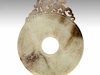 A chinese celadon jade ‘chilong’ bi disc, late warring states period to early western han dynasty, l 14 cm