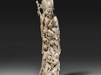 A chinese ivory sculpture of a figure with flowing robes and a branch of lotus buds, signed on the bottom, late qing dynasty (1850-1912), h 46 cm - ca. 3000g (+)