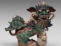 A chinese polychrome glazed roof tile ornament of a buddhist lion, ming dynasty, total h 38 - l 46 cm