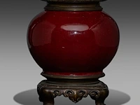 A chinese sang-de-boeuf jar, fixed with bronze mounts, qing dynasty, total h 24,5 cm