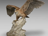 A cold-painted vienna bronze eagle on a rock 30.5 x 42 cm. (12.00 x 16.53 in.)