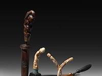 A collection of indonesian tribal circumcision items and phallic handles of a kris, sasak people, lombok, h 28 cm (tallest)