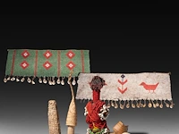 A collection of kapssiki 'cache sexe', penis sheaths, and a fertility doll