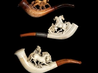 A collection of three meerschaum smoking pipes decorated with horses smallest: 13 cm. (5.12 in.), largest: 16 cm. (6.29 in.)
