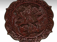 A fine chinese carved cinnabar lacquer 'figures in a mountainous landscape' bracket rim plate, with a qianlong mark, 18thc/19thc, ø 20,5 cm