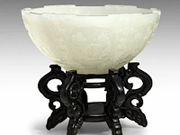 A fine chinese carved white jade 'twelve zodiac' bowl, late qing/ republic period, fitted on a wooden stand, total h 9 cm
