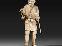 A fine japanese ivory okimono of a farmer holding some crop in one hand and an axe in the other, signed, meiji period (1868-1912), h 25 cm - 591g (+)