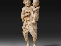 A fine japanese ivory okimono of a farmer showing his son a rat, signed, meiji period (1868-1912), h 15 cm - 206g (+)