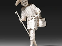 A fine japanese ivory okimono of a fisherman carrying his basket, a spear and a fish, signed, meiji period (1868-1912), h 22 cm - 432g (+)