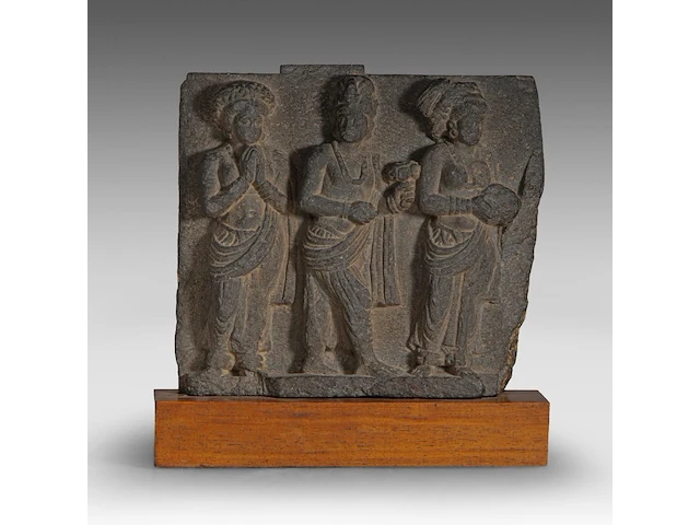 A gandharan grey schist relief panel depicting worshippers of the buddha, ancient region of gandhara, kushan period, 2nd-3rd c, fixed on a wooden base, total h 35 cm (+) - afbeelding 1 van  6