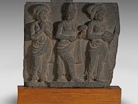 A gandharan grey schist relief panel depicting worshippers of the buddha, ancient region of gandhara, kushan period, 2nd-3rd c, fixed on a wooden base, total h 35 cm (+)