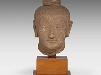 A gandharan stucco head of the buddha, ancient region of gandhara, 3rd-5thc, on a wooden base, total h 29 cm