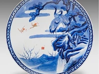 A japanese arita ware dish with a landscape of cranes and a waterfall, marked, 19thc, ø 46 cm