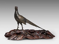 A japanese bronze and gilt okimono of a pheasant, fixed on a wooden tree trunk-form base, meiji period (19thc), total l 60 - h 36 cm