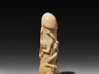A japanese carved hippo ivory 'dildo harigata', embraced by female figures 15 cm. (5.91 in.)
