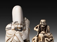 A japanese ivory netsuke of a rakan, edo period (probably 18thc), h 4,5 cm - 26g added; a japanese ivory netsuke of jurojin, meiji/taisho period (early 20thc), h 5,5 cm - 34g (+)
