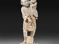 A japanese ivory okimono of a fisherman with his son, who is holding a turtle on a string, signed, meiji period (1868-1912), h 15,5 cm - 248g (+)