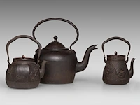 A japanese 'phoenix and dragon medallion' and a 'figure in a riverscape' cast iron tetsubin kettle, both signed, meiji period, total h 24,5 - 24,8 cm