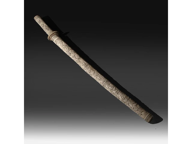 A japanese wakizashi in a bone saya, elaborately sculpted with a battle of samurai, meiji period (1868-1912), total l 78 cm - sword l from habaki - 56 cm - afbeelding 1 van  9