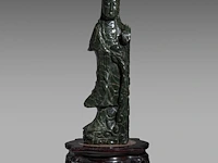 A large chinese green jade carving of a standing guanyin, late qing, h 80 cm - added a wooden base, h 45,5 cm