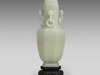 A large chinese jade carving of a lidded vase, republic period, fitted on a wooden base, total h 30,5 cm