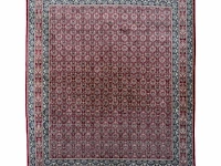 A large woollen oriental persian rug, decorated with flower vases 397 x 301 cm. (156.30 x 118 1/2 in.)