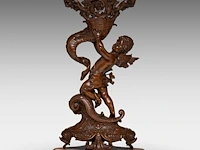 A napoleon iii patinated bronze group of cupid holding a horn of abundance (cornucopia) 54 cm. (21.26 in.)