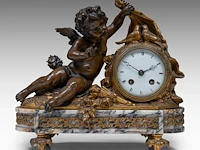 A neoclassical marble, gilt and patinated bronze mantle clock with cupid on top, ca. 1880 33 x 35 cm. (12.99 x 13.77 in.)