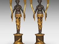 A pair of empire gilt and patinated bronze figural candlesticks with an allegory of america 42 cm. (16.53 in.)