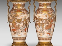 A pair of japanese satsuma ware vases, decorated with scholars gathering in a garden, fixed with bronze mounts, late meiji, total h 55,5 cm