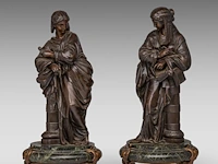 A pair of patinated bronze sculptures of neoclassical beauties, on a vert de mer marble base 40 cm. (15 3/4 in.)