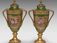 A pair of polychrome and gilt limoges porcelain vases and covers, decorated with hand-painted flowers 42 cm. (16.53 in.)