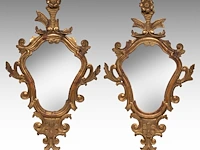 A pair of rococo-style giltwood wall mirrors, 19thc 58 x 35 cm. (22.82 x 13.77 in.)