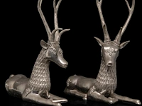A pair of vintage mid-century silver-plated brass sculptures of lying deer 47 x 46 cm. (18 1/2 x 18.10 in.)