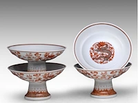 A set of four chinese iron-red 'dragons amongst clouds' tazza footed bowls, with a guangxu mark, h 10 - ø 18,5 cm