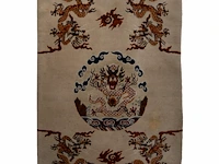 A sino-tibetan/mongolian 'dragon medallion' woollen rug on ivory ground, 20thc 175.5 x 122 cm. (69.09 x 48.03 in.)
